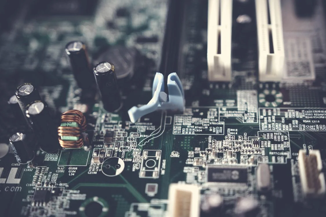 Tilt-shift view of a computer motherboard, representing the three-layer architecture behind a centralized IP platform for consultants