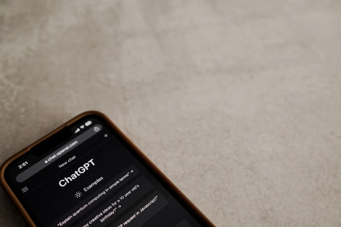 A smartphone showing a generic AI chat interface on a plain surface, the tool most people use to handle routine client questions without any client context