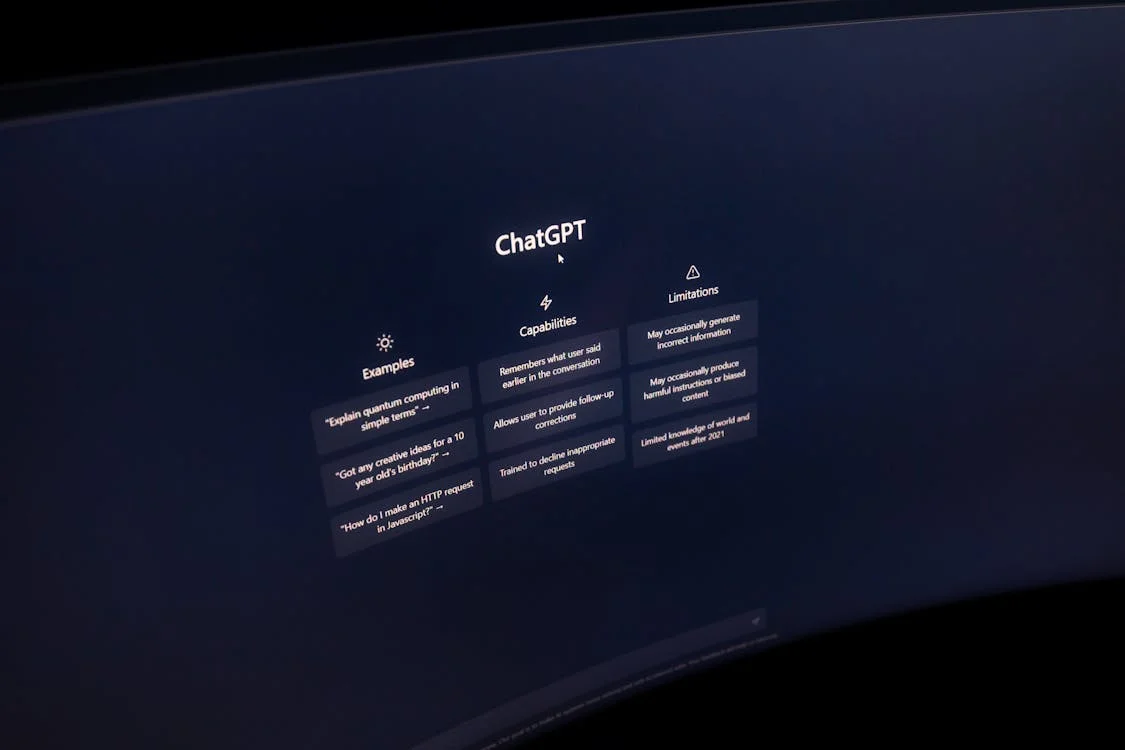 ChatGPT interface glowing on a monitor in a dark room — the baseline every consultant is using, and what purpose-built AI goes beyond