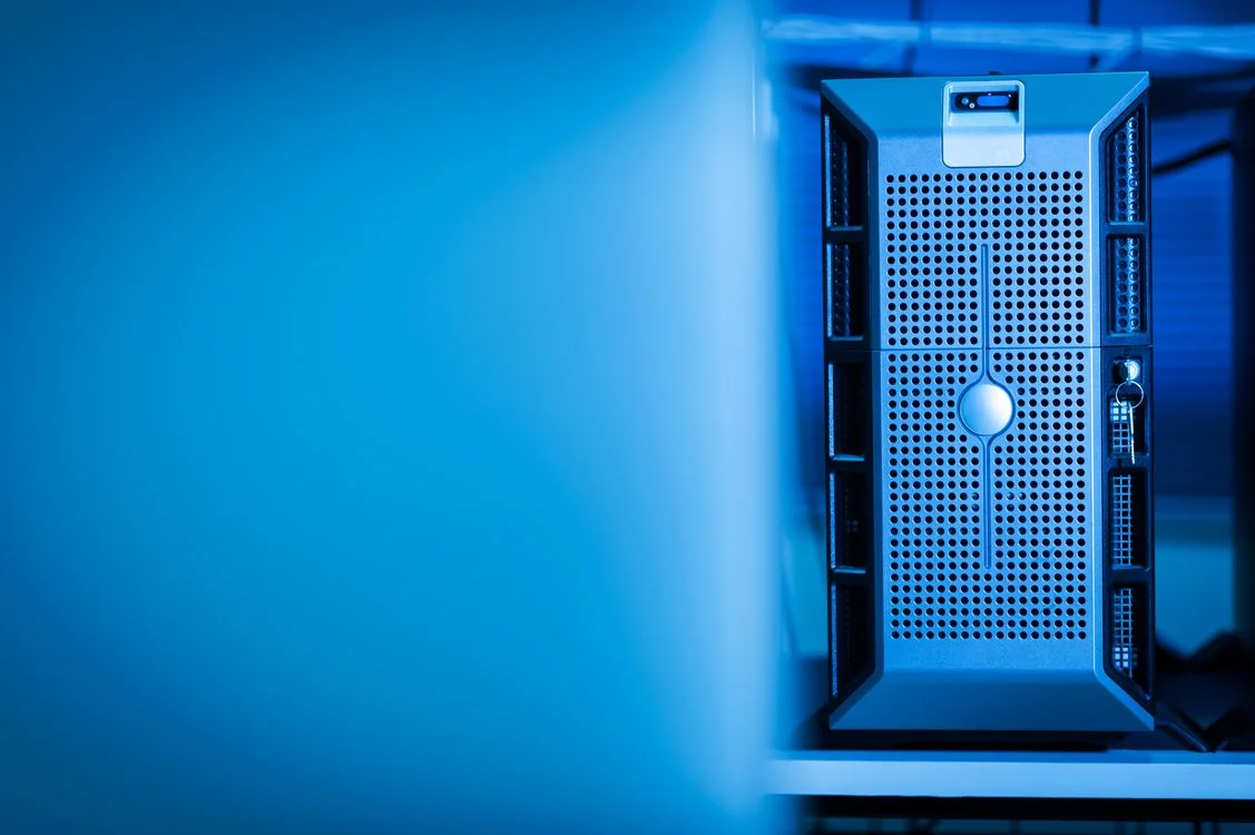 Server hardware lit in blue inside a modern data centre, representing the delivery system behind a productized service with AI