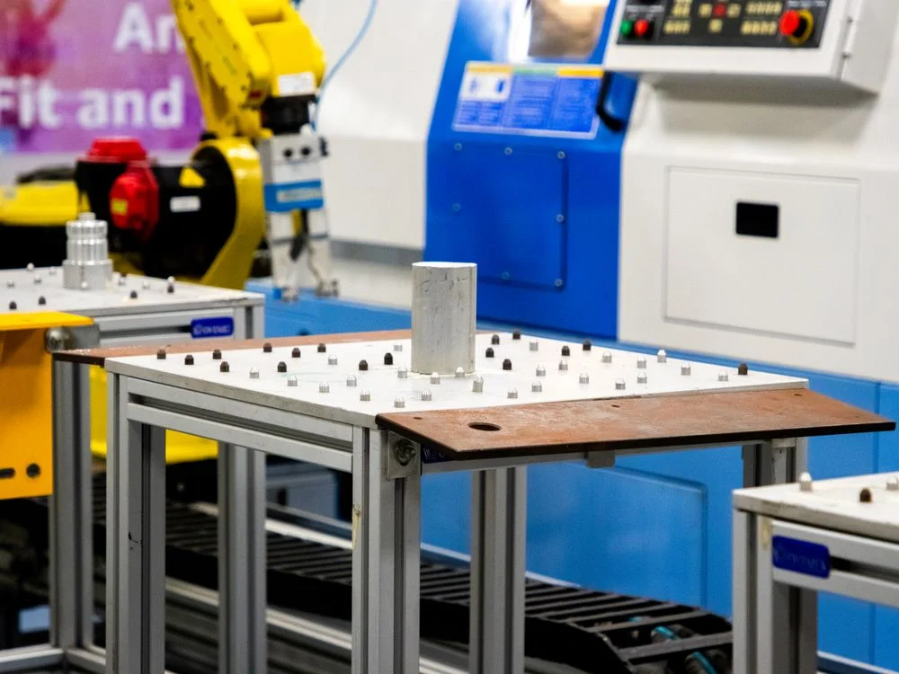 Industrial automation machinery running a controlled process, illustrating a business model where AI lowers the cost of delivery rather than the cost of the product