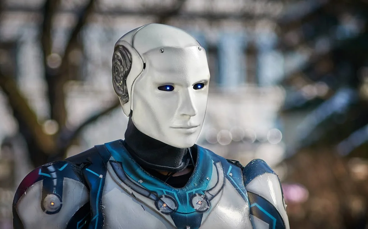Futuristic humanoid robot with metallic armor and glowing blue eyes — the intelligence layer between your expertise and every client
