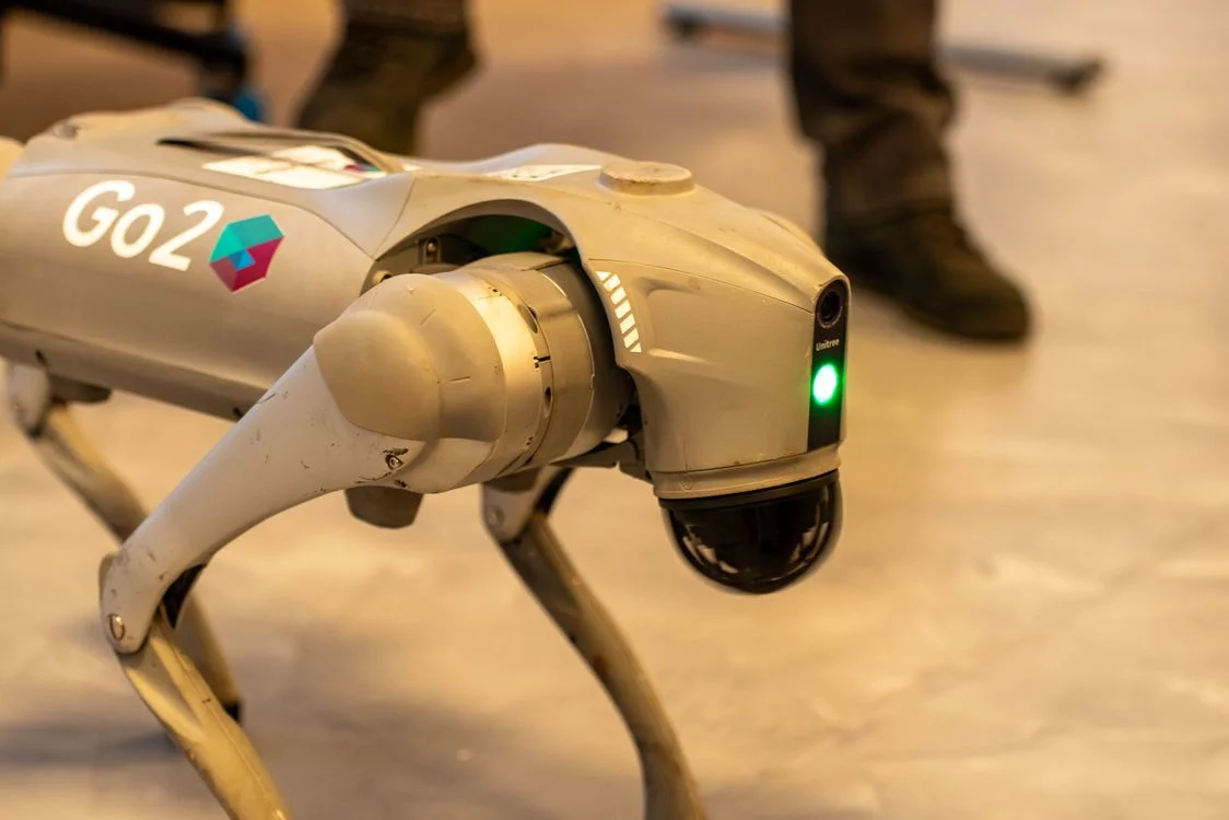 Advanced robotic dog moving through an indoor space, representing an AI workspace that runs one methodology reliably across every client