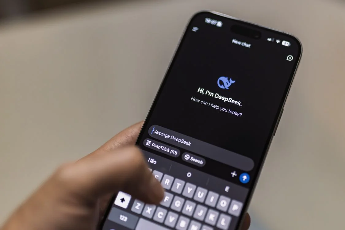 A hand holding a phone open to an AI chat interface asking how it can help, showing why generic chat cannot handle routine client questions