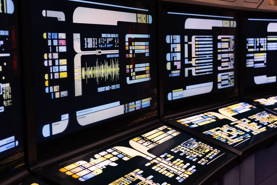Command center screens displaying live system data, representing testing whether AI is mixing client data between workspaces