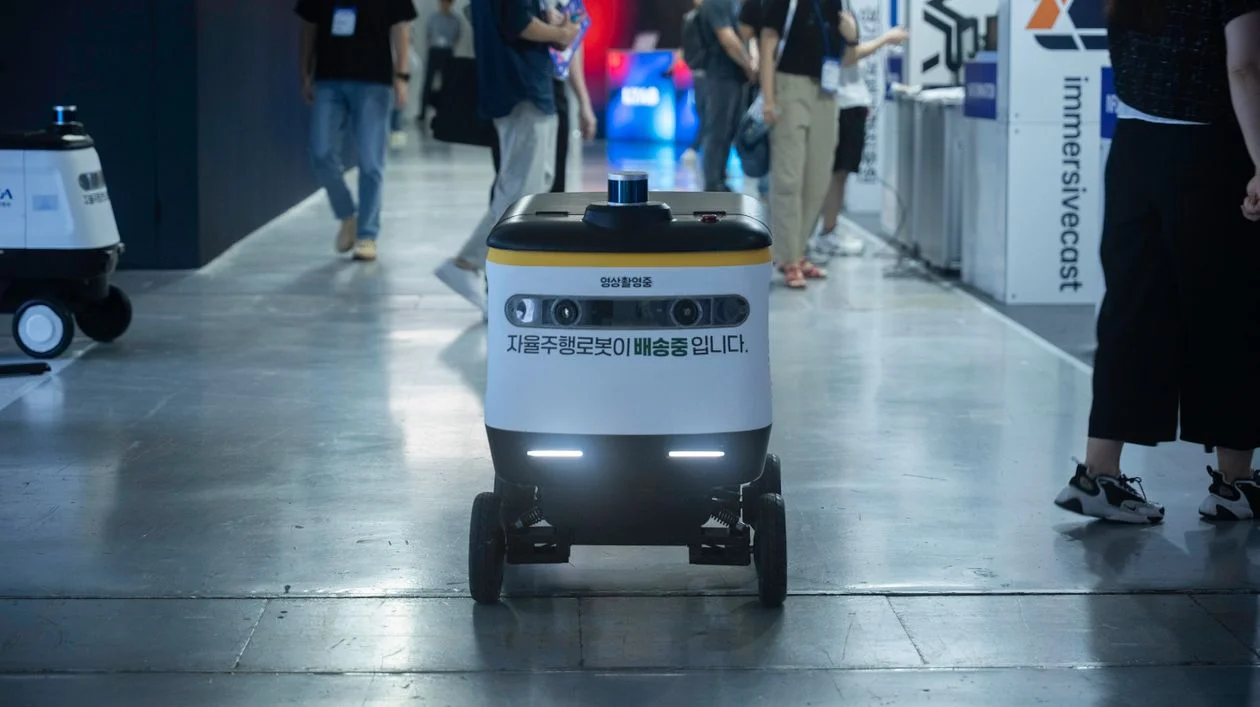 Autonomous delivery robot at a technology event, representing the system that carries client delivery once your IP is centralized