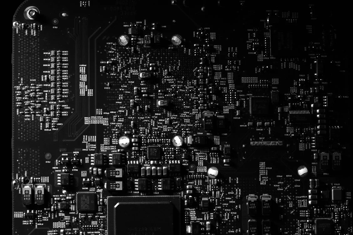Macro view of a black circuit board, representing the architecture that decides whether an AI alternative keeps client data separate