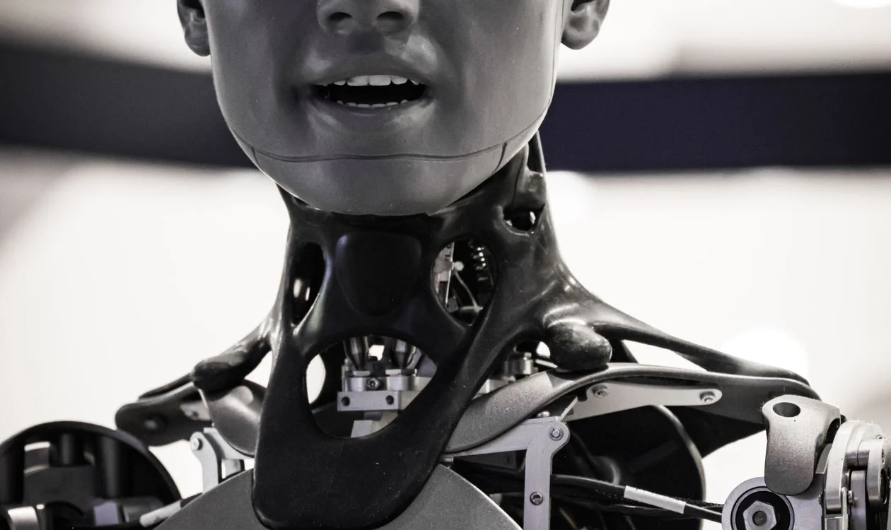 Close-up of a humanoid robot at a technology exhibition, representing a system built to hold and apply your expertise instead of leaving it in your head