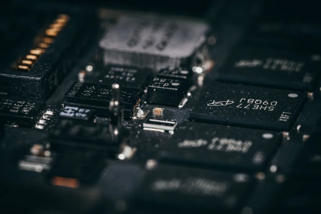 Macro view of circuit board components, representing the loaded frameworks that let one methodology reach a hundred clients without being rebuilt