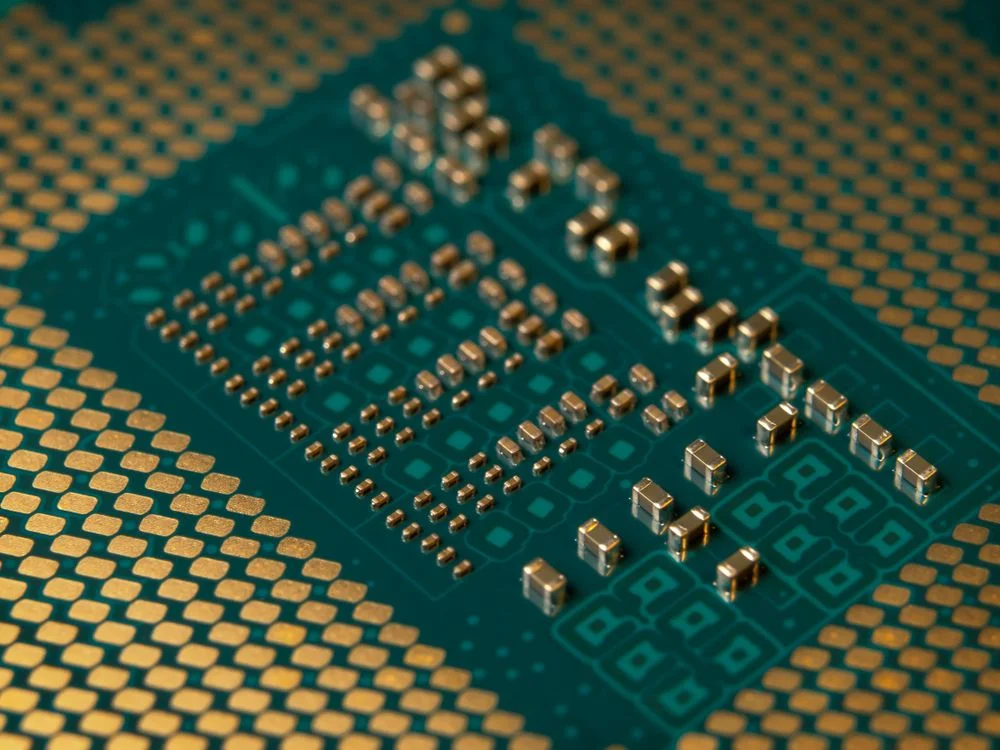 Macro view of a green microprocessor with gold contacts, representing the structured system that keeps each client's data isolated when using AI
