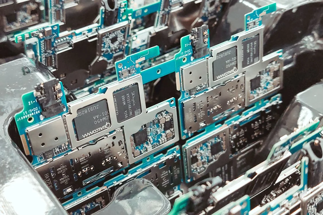 Macro view of a silver and blue circuit board: the structured system that lets a coachsultant apply one method to every client