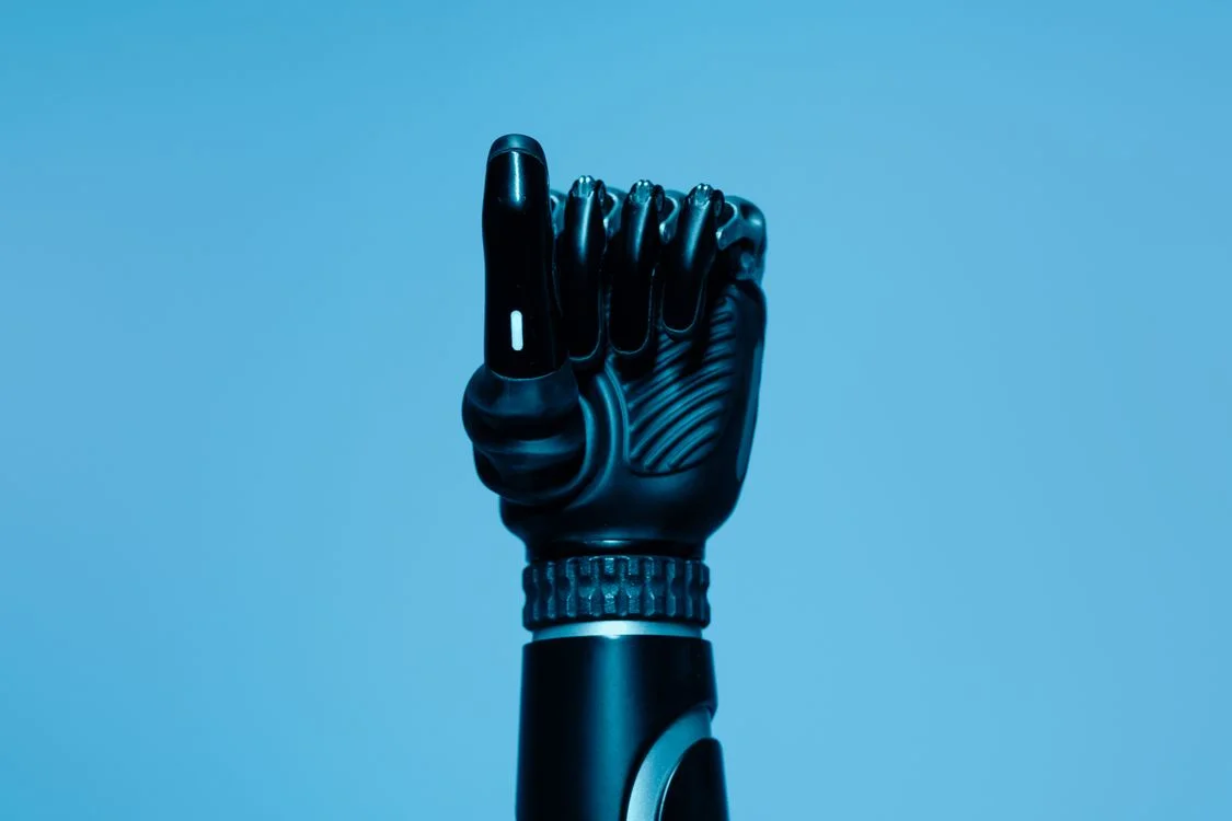 A black robotic hand raised against a blue background, representing an AI system that keeps client data separate by design rather than by careful prompting