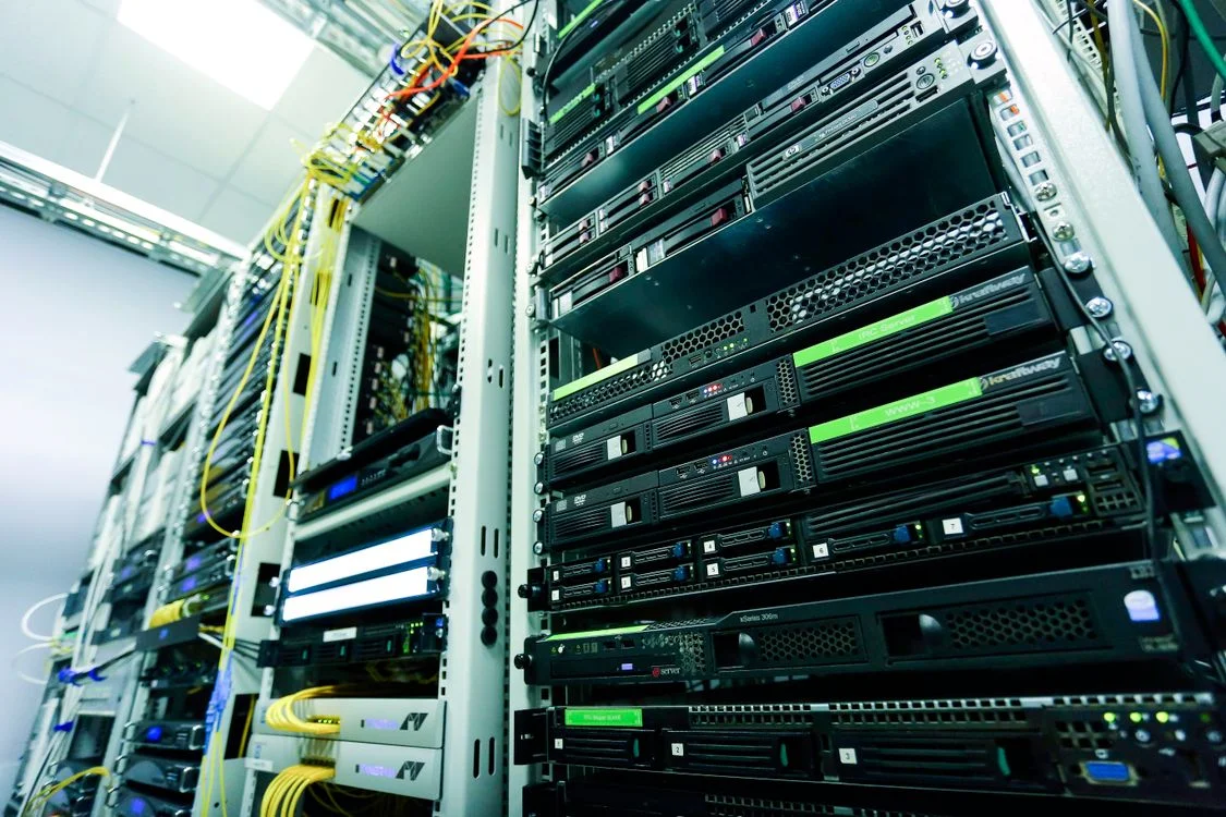 Green-lit server stack in a data centre, representing a system that keeps every client’s data in its own isolated workspace rather than one shared pool