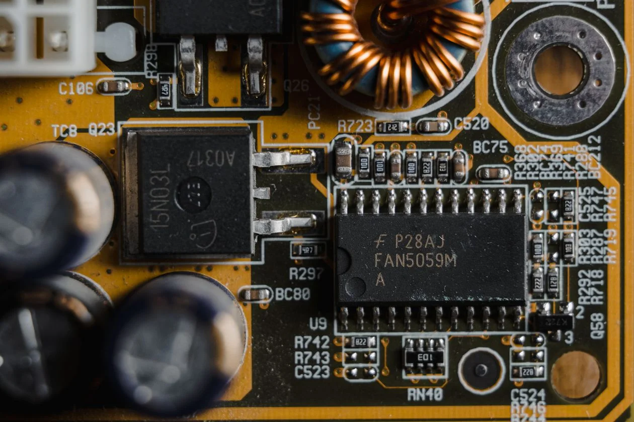 Macro view of golden microchips on a circuit board, representing the Brain layer of an AI knowledge base for consultants that holds one methodology and applies it everywhere