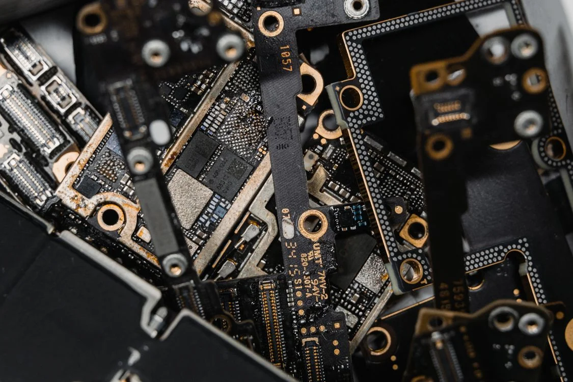 Stack of disassembled circuit boards, representing the five-tool stack most coaching practices run on before the future of high-ticket coaching arrives