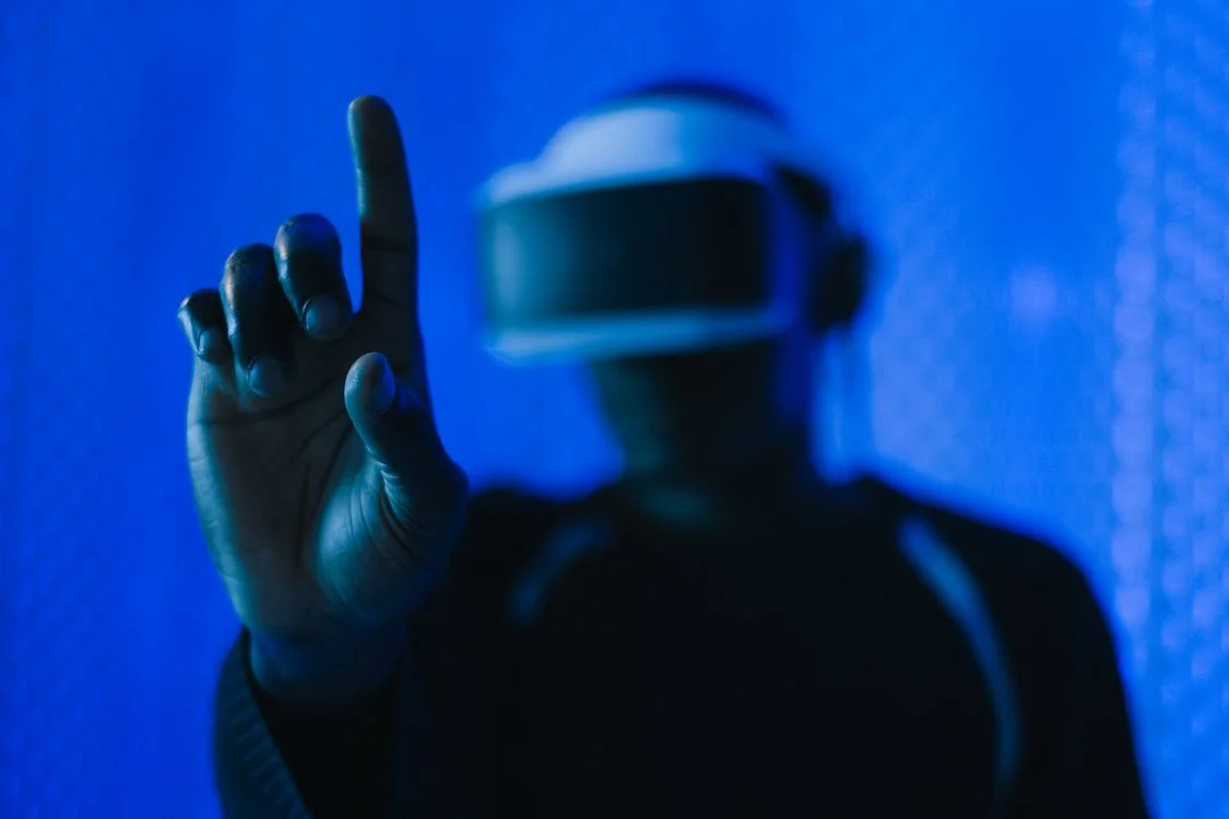 A person in a VR headset reaching toward a glowing blue interface, representing the search for AI alternatives to ChatGPT for client work