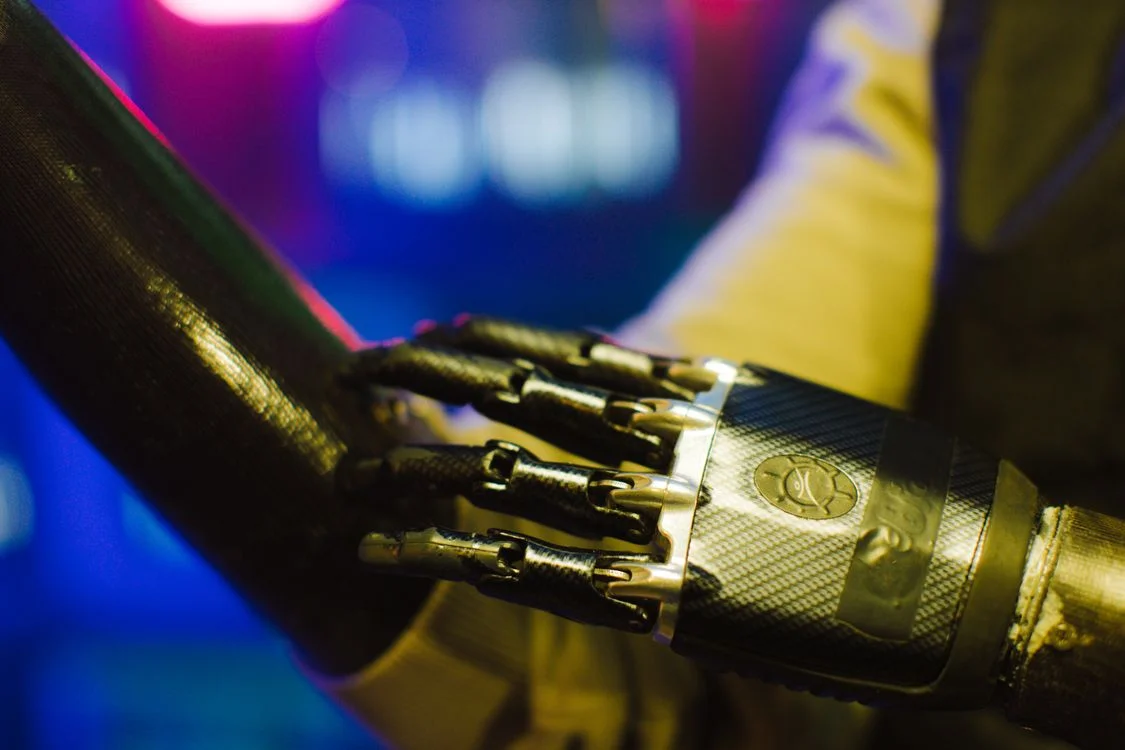 Two robotic hands meeting under neon light, representing separate AI workspaces per client where one methodology reaches every sealed client environment