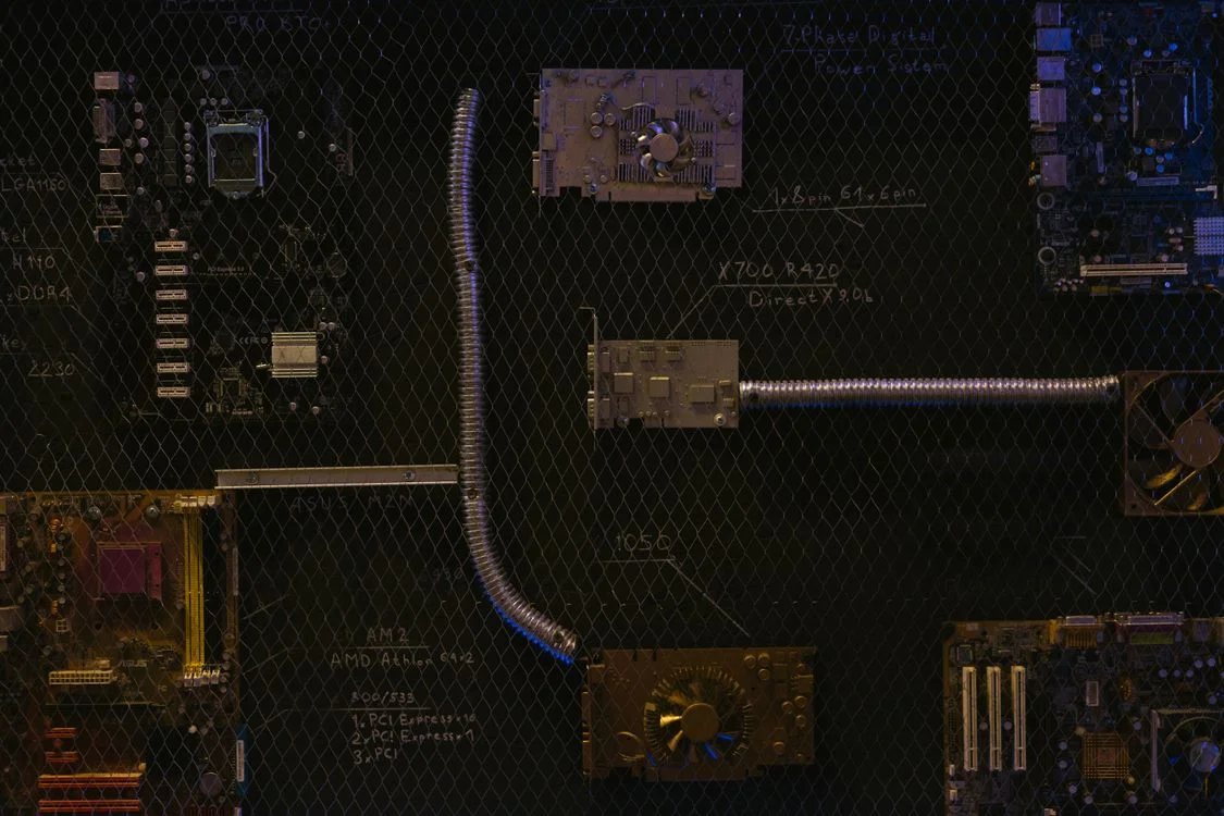 Abstract arrangement of circuit boards and glowing components, representing the architecture of an AI workspace that isolates each client by design