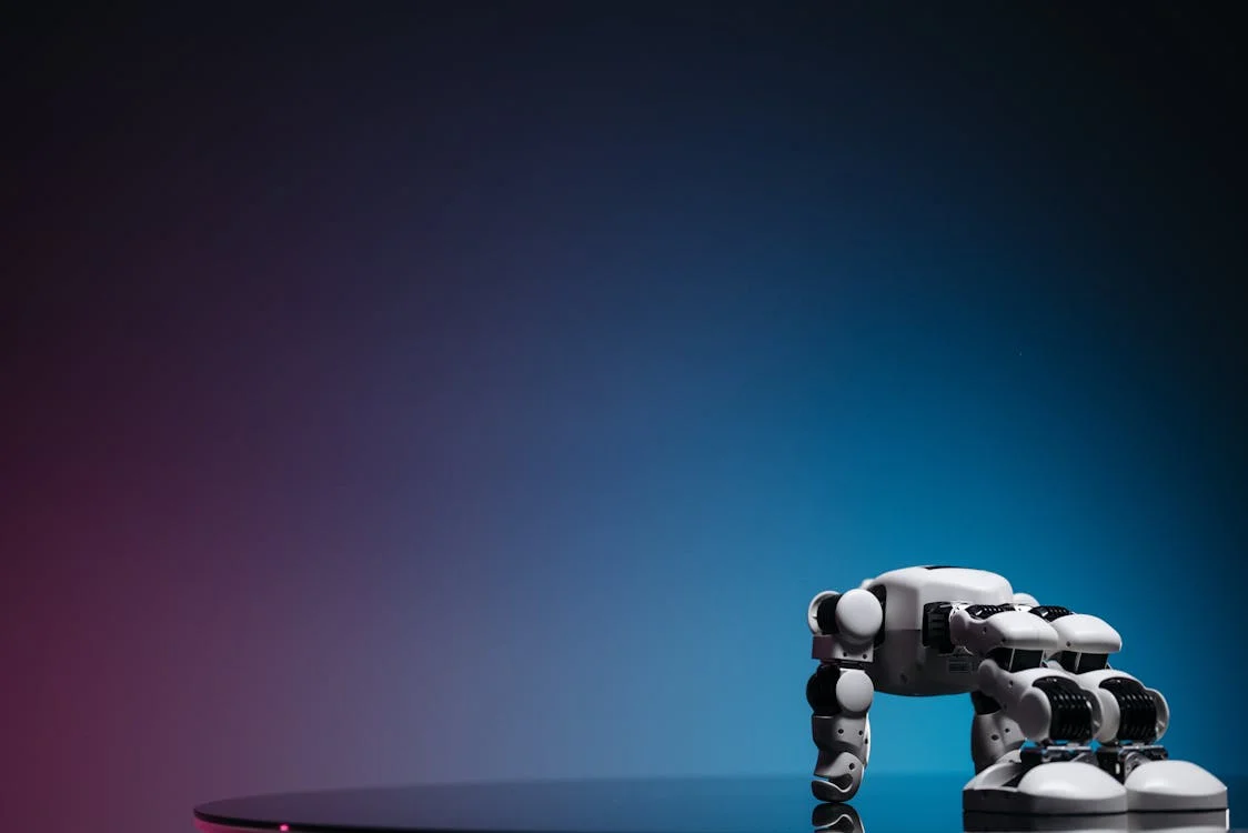 White robot on a reflective surface with a blue-pink gradient — the AI model built to replicate your expertise at scale