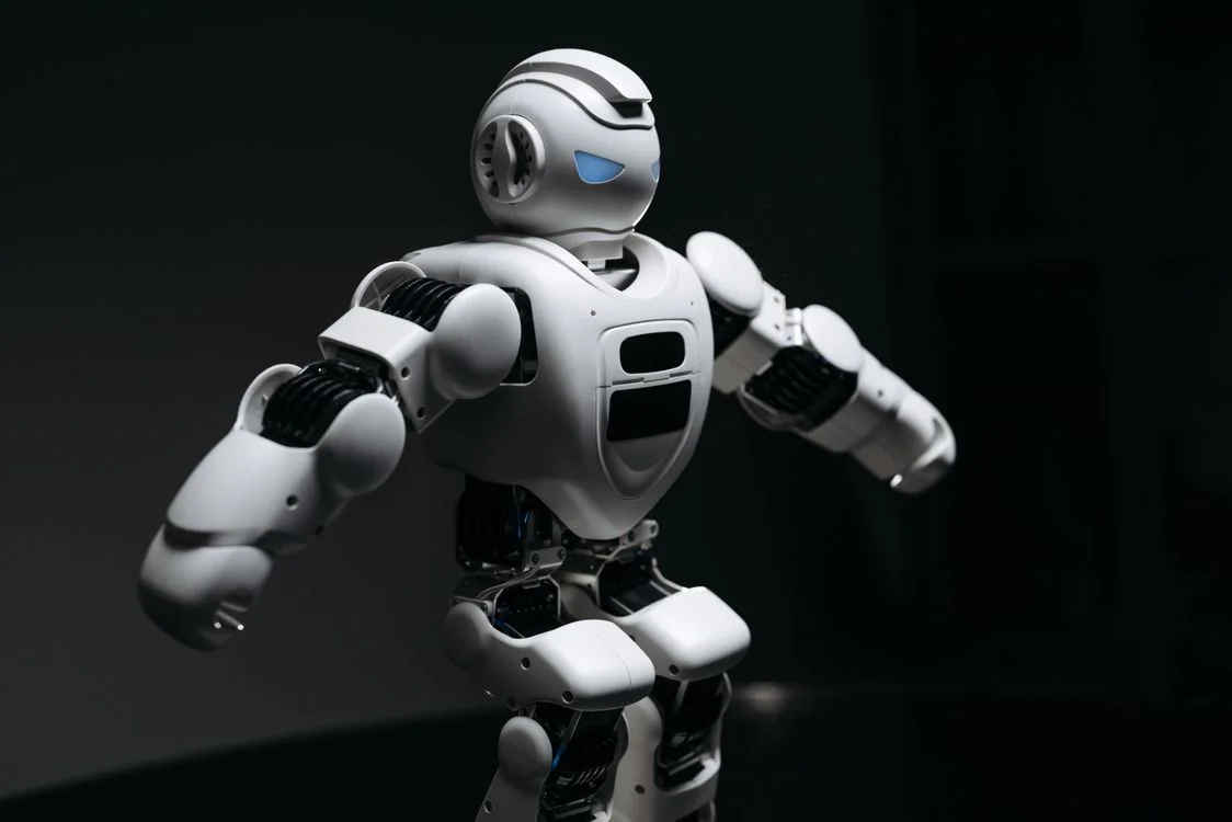 White robot standing on a reflective surface, representing one methodology applied consistently across every client workspace