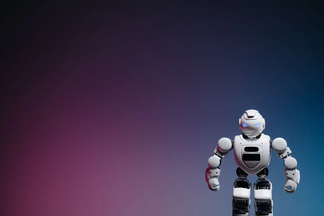 Sleek white robot against a blue and pink gradient, representing a centralized IP platform that holds one methodology and applies it to every client