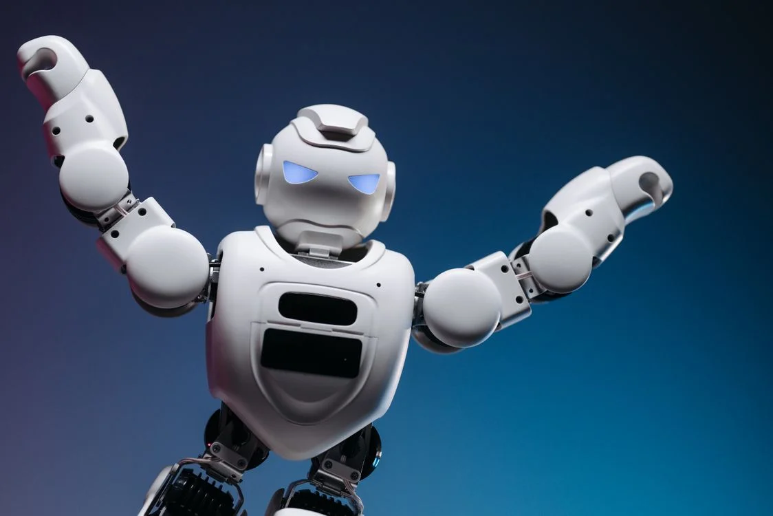 A white humanoid robot in a confident pose against a blue background, representing an AI system built to apply your methodology to every client