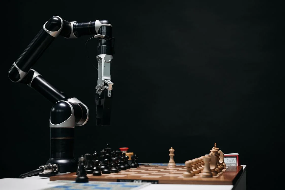 White humanoid robot in a studio, representing the routine coaching tasks AI can already handle in the question of whether AI will replace coaches