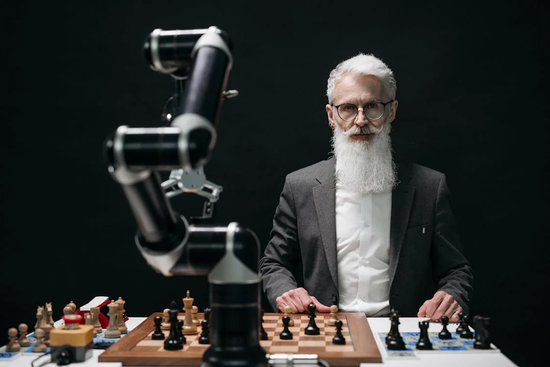 A person playing chess against a robotic arm, representing the shift from doing the thinking yourself to directing an AI brain that applies your methodology