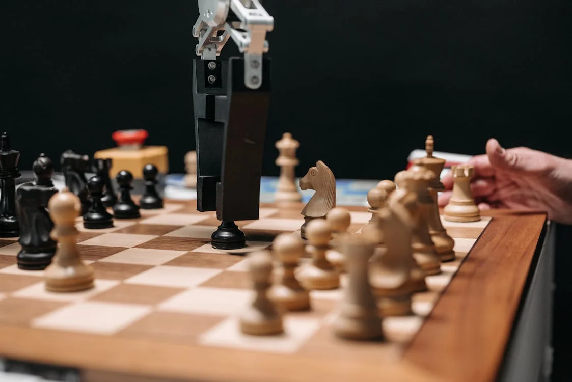 Close-up of a robotic arm moving a single chess piece, representing isolated per-client AI memory for marketing agencies