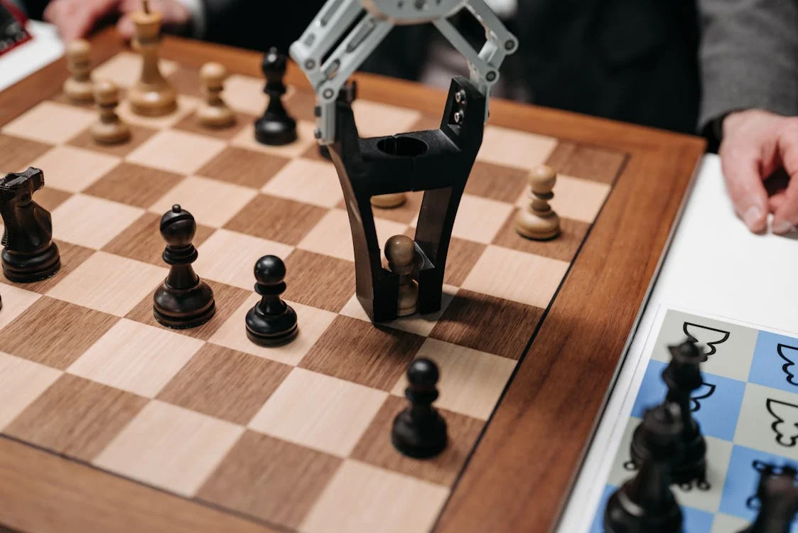 Robotic arm engaged in a chess match — AI tools that think strategically on behalf of the consultant