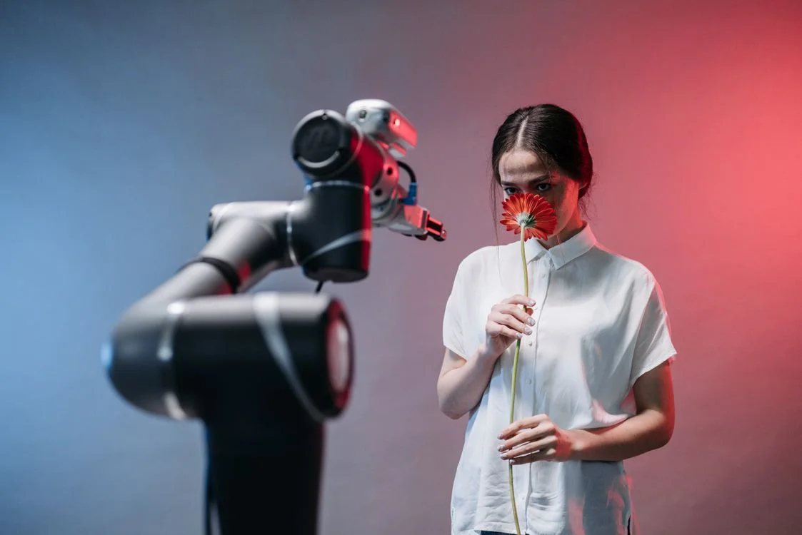 Robotic arm handing a flower to a person, representing the controlled boundary that stops AI mixing client information