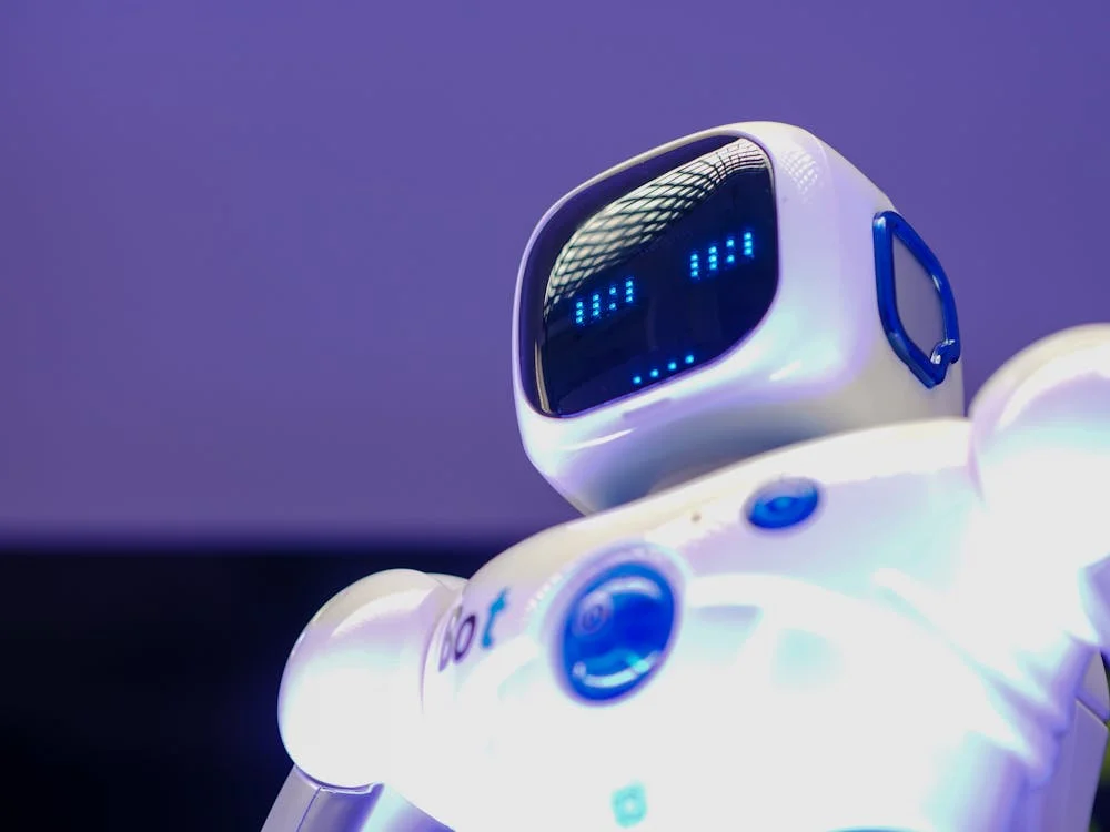 Humanoid robot with glowing digital face — the AI system trained on your methodology, ready to deploy across every client