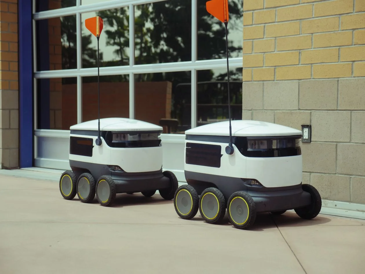 Two autonomous robots operating independently, representing AI systems that run client work in separate, isolated lanes for data privacy