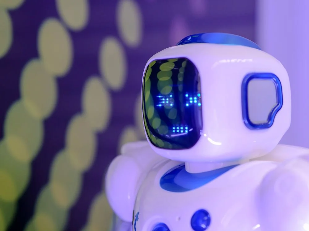 Blue and white humanoid robot with a glowing display, representing AI that needs structure to know which client it is serving
