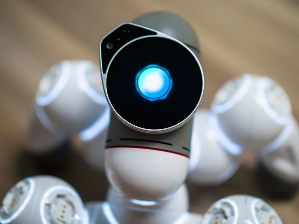 Close-up of a futuristic robot with a glowing head, representing an AI workspace that carries one methodology into every client environment