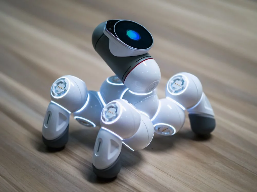 A robotic pet dog with glowing sensors on a wooden floor, representing single-purpose AI tools that impress but do not carry agency operations