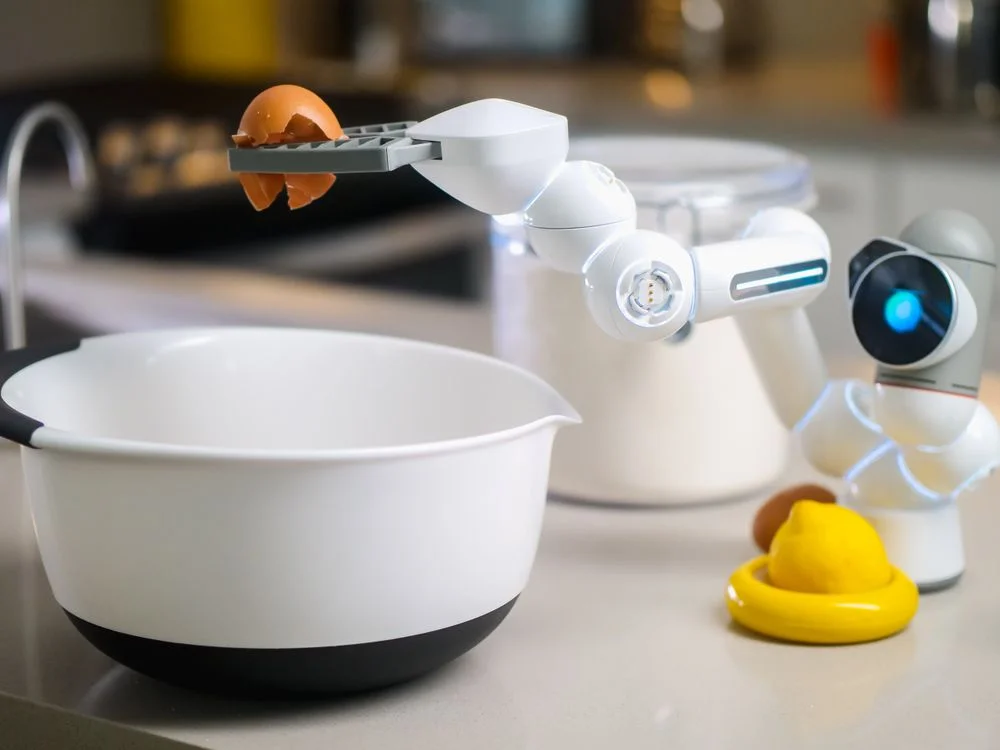 A robotic helper cracking an egg into a bowl in a kitchen, illustrating AI to handle routine client questions and repeatable tasks